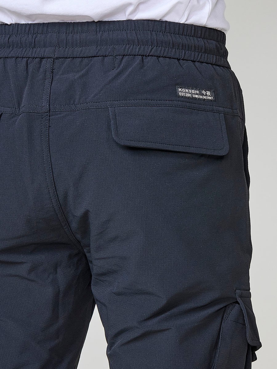 Pantalón jogger largo de hombre negro, 98% algodón y 2% elastano, con bolsillos y cierre delantero con cremallera y botón.