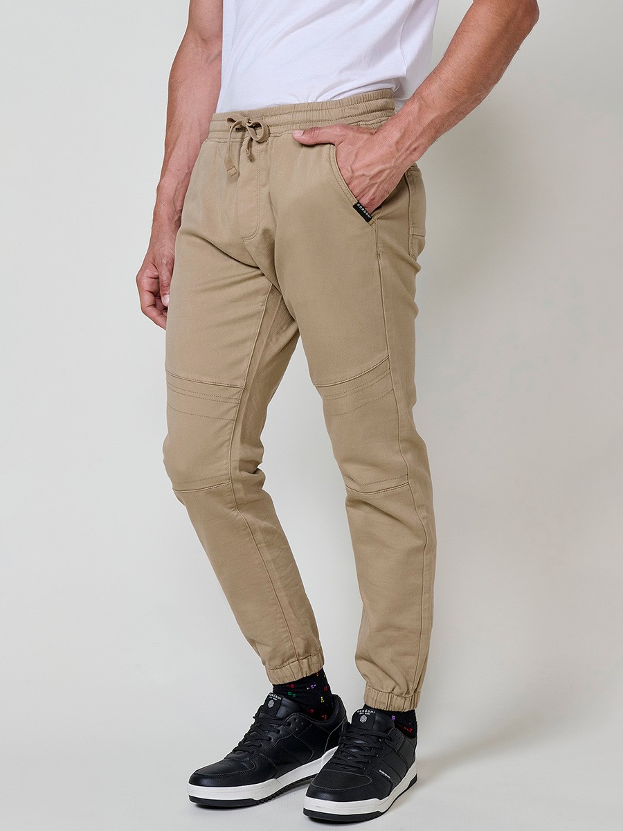 Pantalón jogger de hombre en color beige, con bolsillos laterales, cintura elástica y tejido 100% poliéster cómodo y resistente.