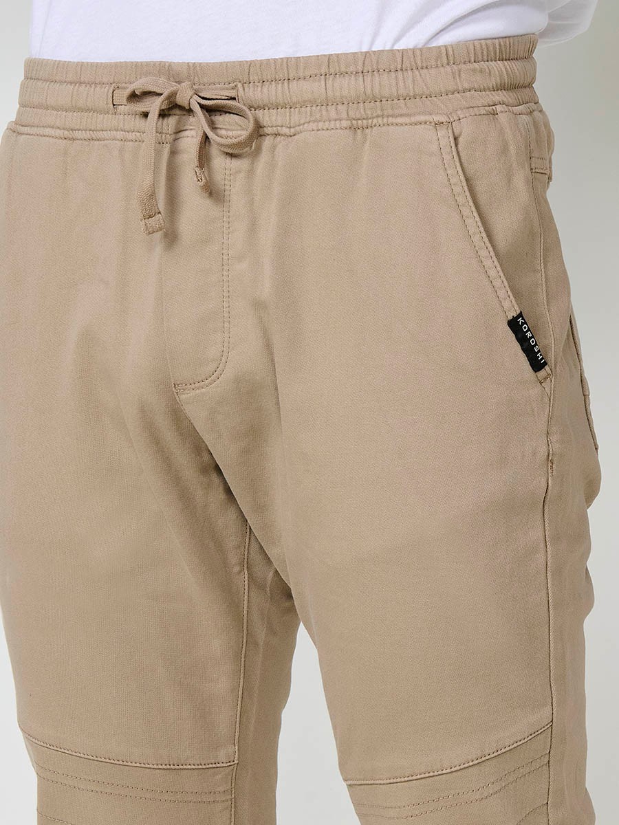 Pantalón jogger de hombre en color beige, con bolsillos laterales, cintura elástica y tejido 100% poliéster cómodo y resistente.