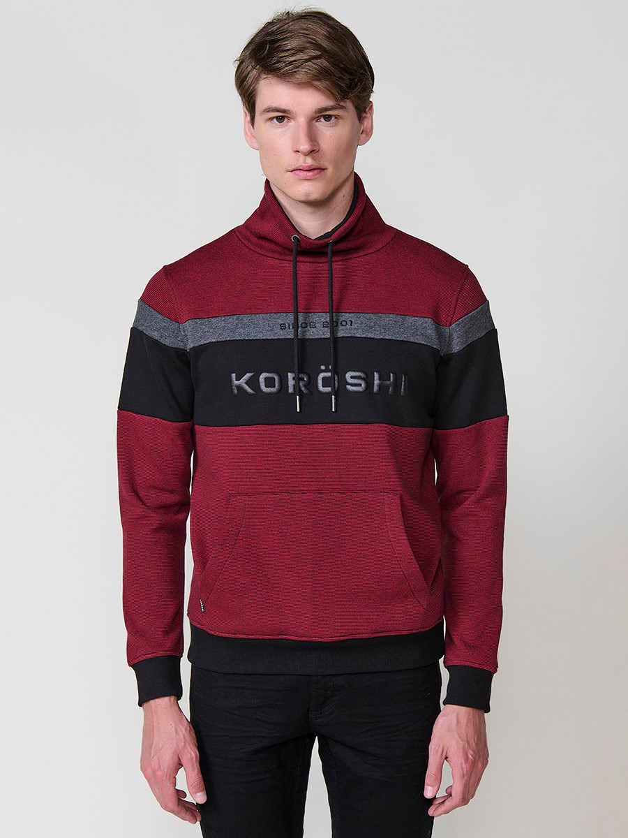 Sudadera de hombre en color rojo con cuello alto ajustable mediante cordón. Tejido mezcla de algodón y poliéster para estilo y comodidad.