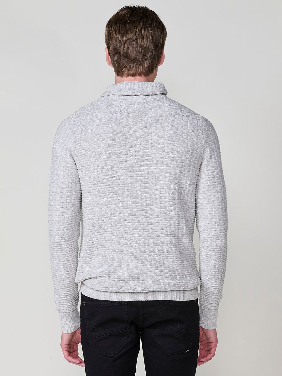 Jersey crudo de hombre en tricot con cuello redondo y manga larga. Confección 100% acrílico para un estilo actual y versátil.