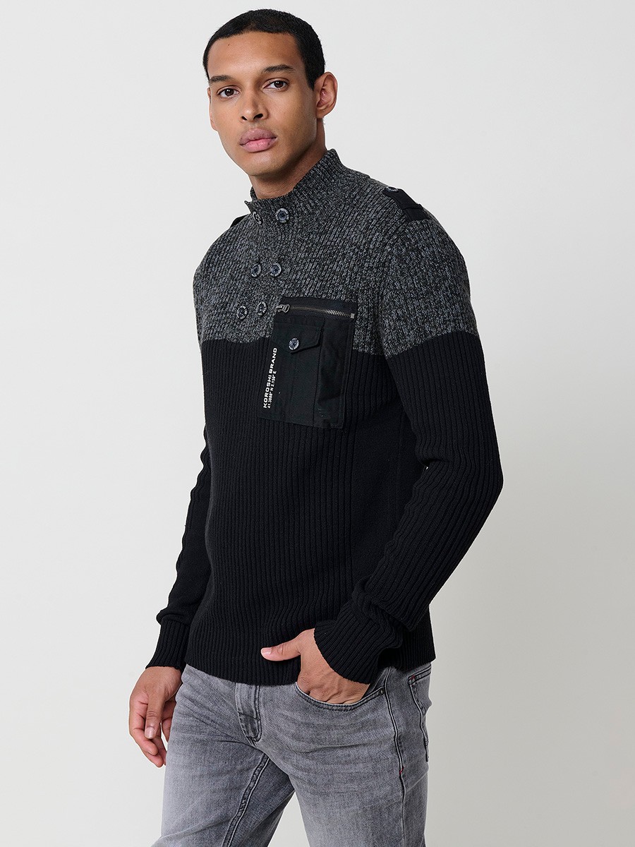 Jersey negro de hombre en tricot con cuello redondo y manga larga. Confección 100% acrílico para un estilo actual y versátil.