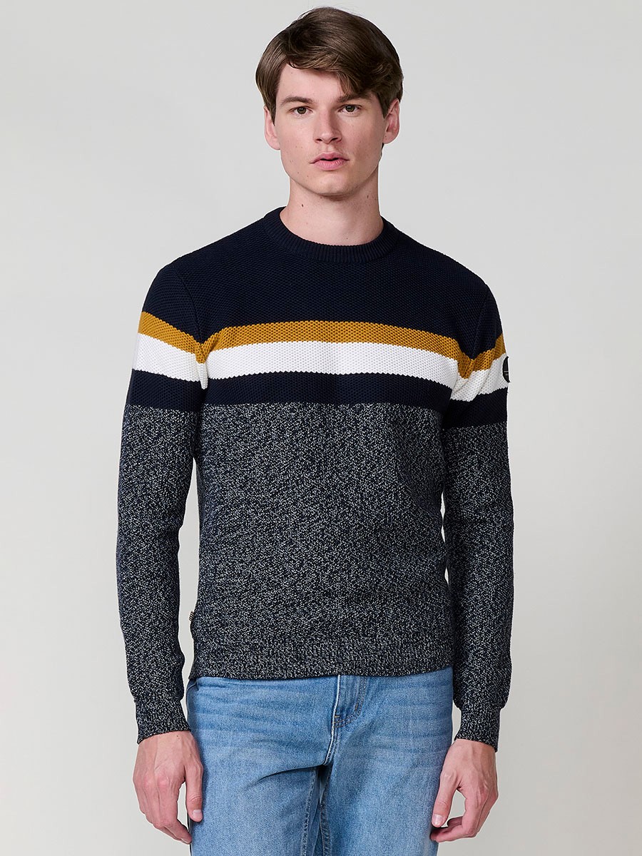 Jersey navy de hombre en tricot con cuello redondo y manga larga. Confección 100% acrílico para un estilo moderno, versátil y cómodo.