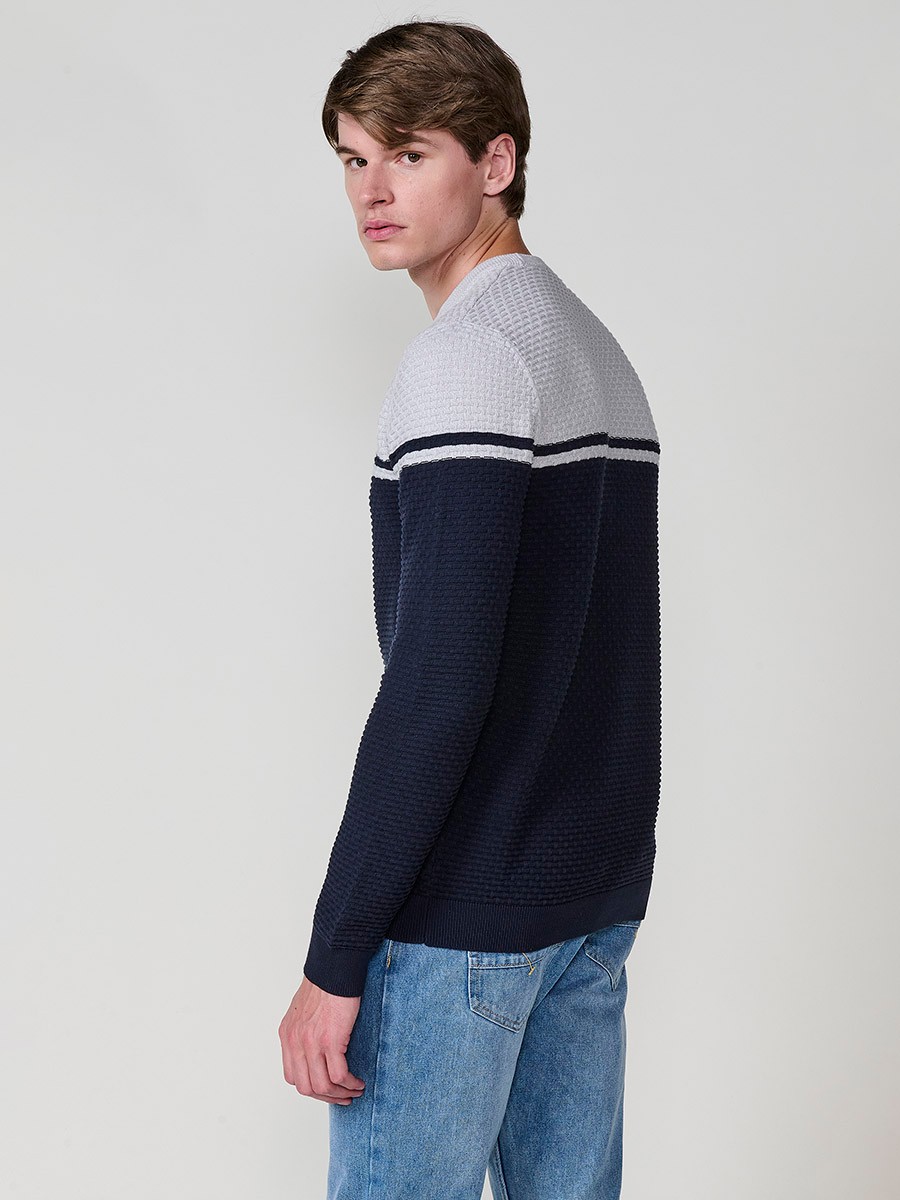 Jersey navy de hombre en tricot con cuello redondo y manga larga. Confección 100% acrílico, cómodo y versátil para cualquier temporada.