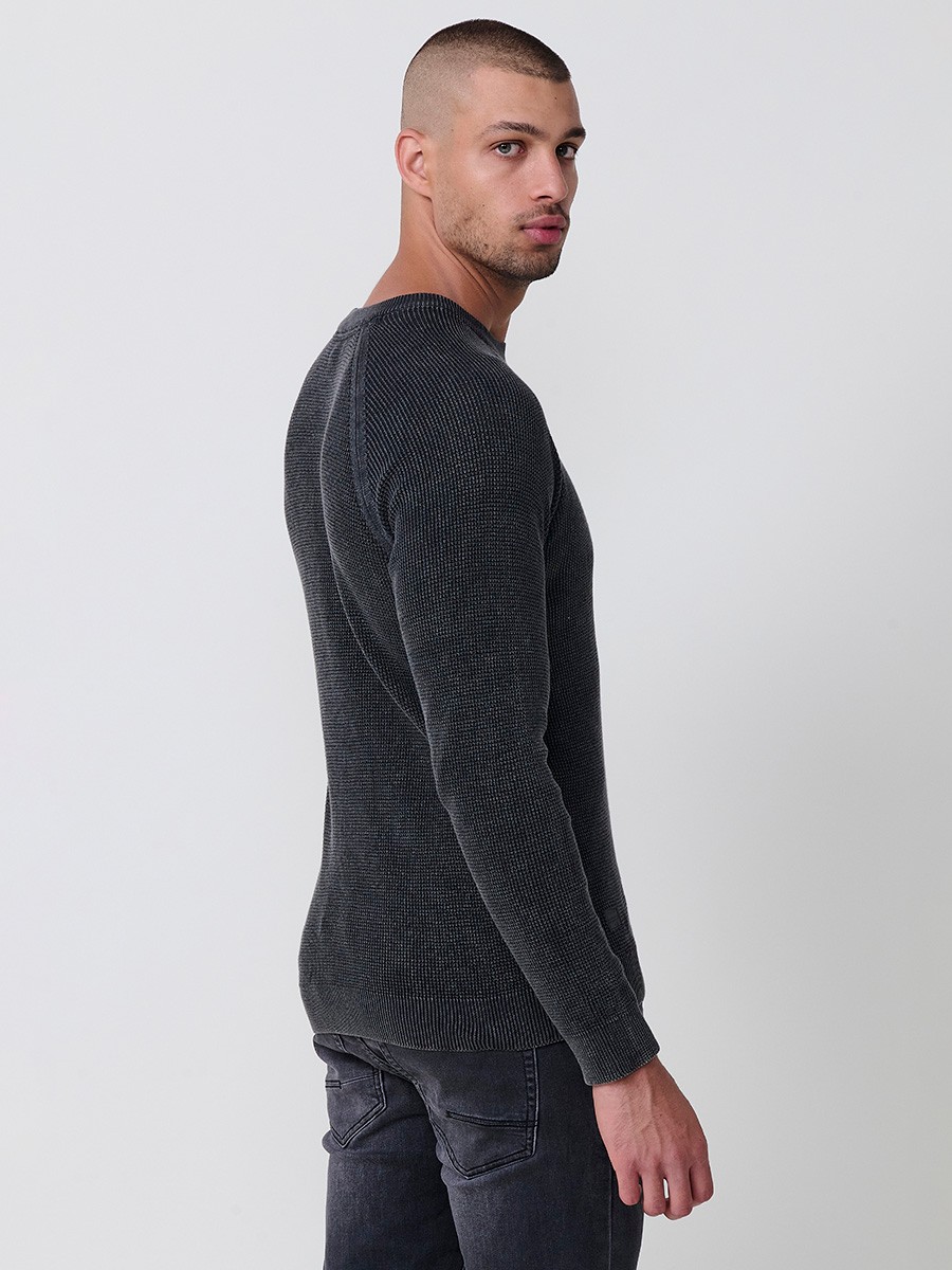 Jersey negro de hombre en tricot con cuello redondo y manga larga. Tejido 100% acrílico, cómodo y atemporal para todas las temporadas.