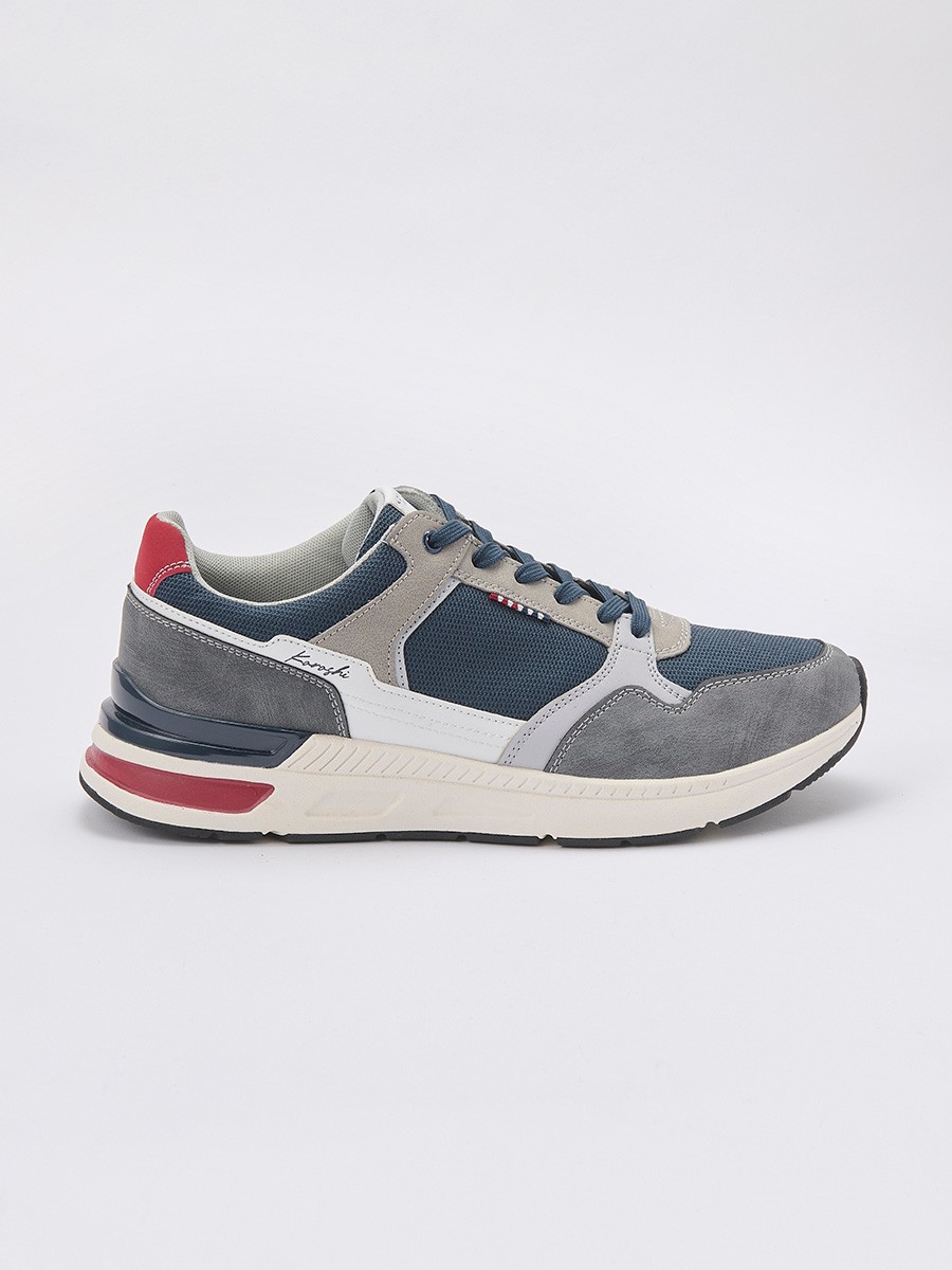 Zapatillas deportivas de hombre en color navy con cordones, confeccionadas en poliuretano y poliéster para comodidad y resistencia.