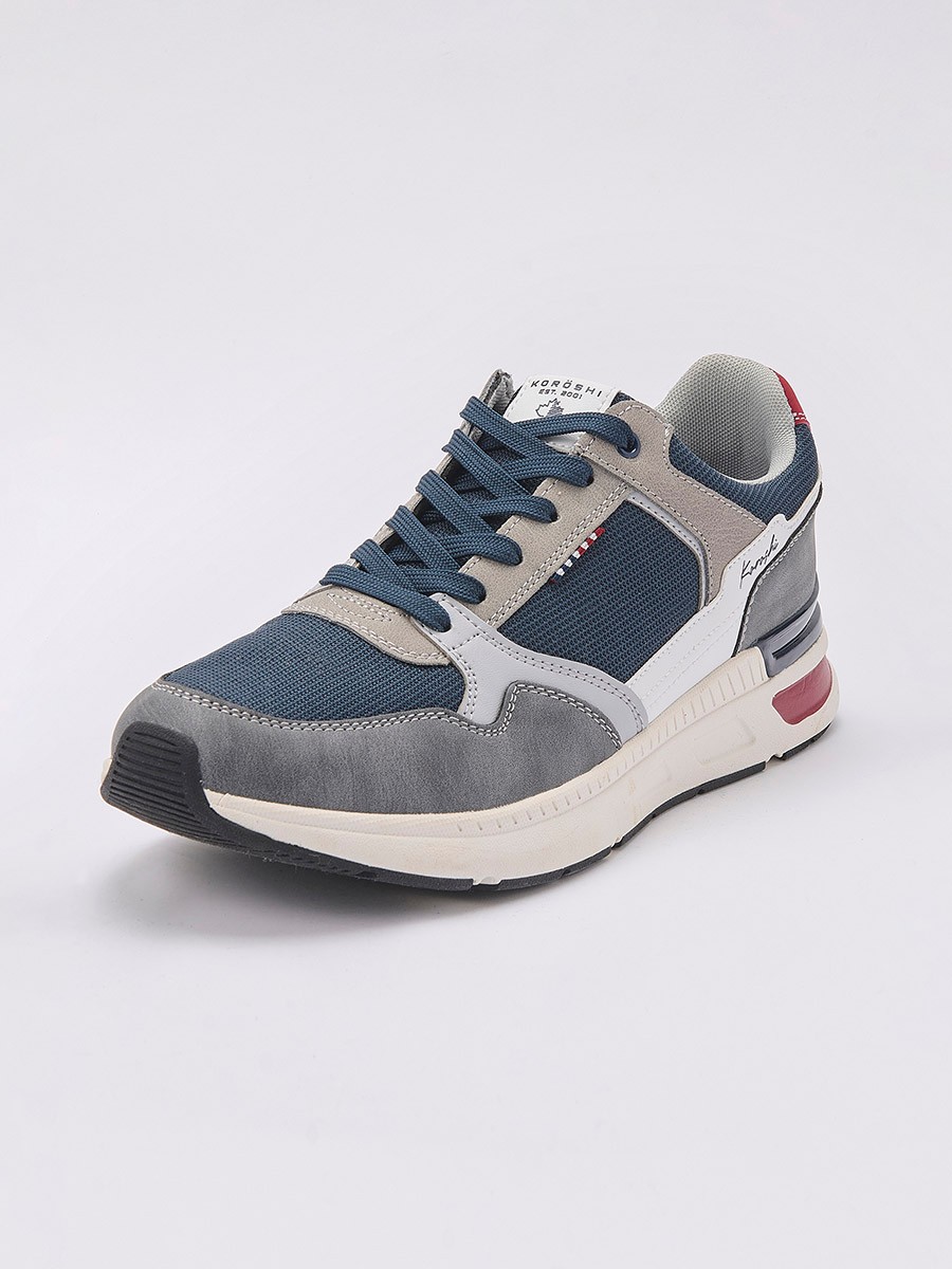 Zapatillas deportivas de hombre en color navy con cordones, confeccionadas en poliuretano y poliéster para comodidad y resistencia.