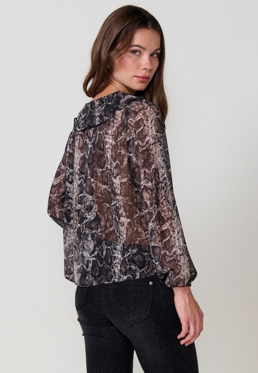Women’s sheer chiffon blouse with animal print, V-neckline with ruffle and long sleeves with ruffled cuffs.