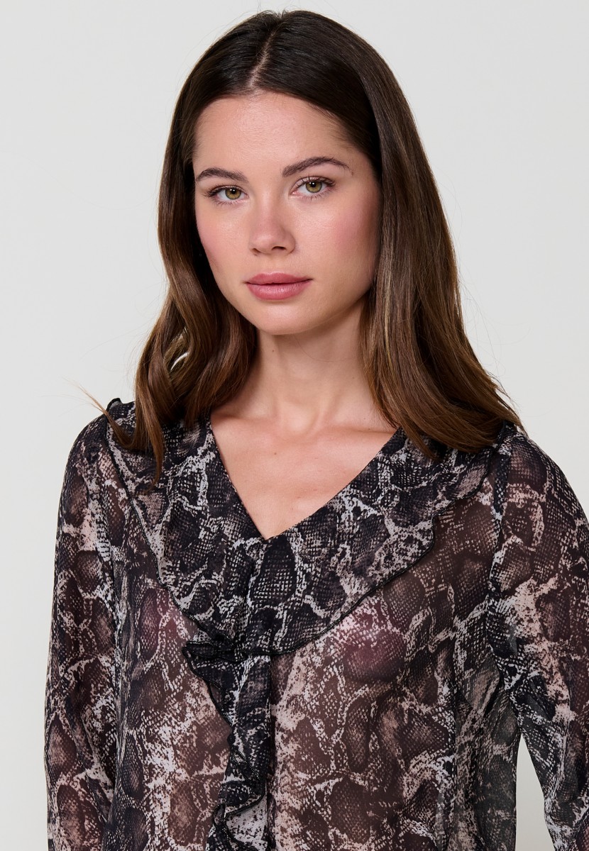 Women’s sheer chiffon blouse with animal print, V-neckline with ruffle and long sleeves with ruffled cuffs.
