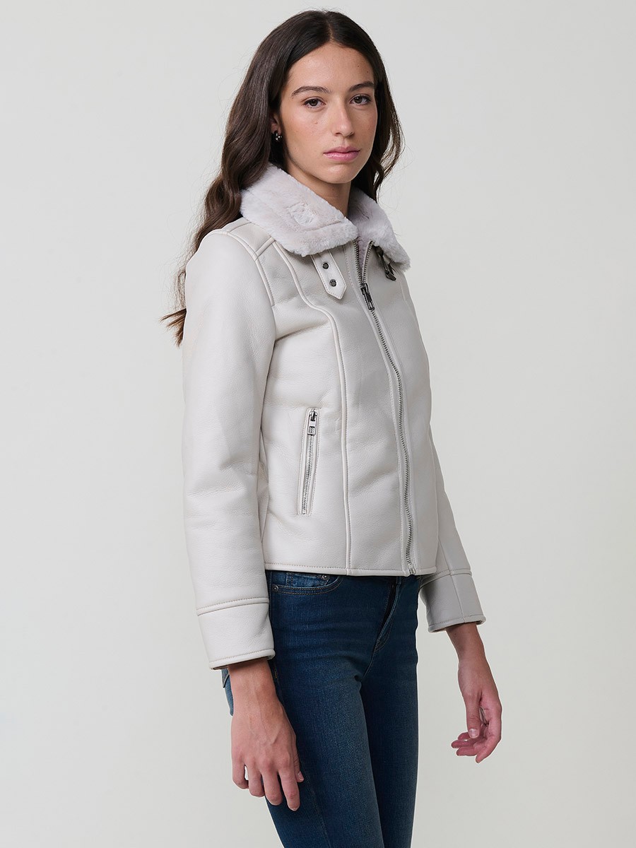 Women’s white double-faced faux leather jacket with faux fur lining, metallic zip pockets and buckle neck detail.
