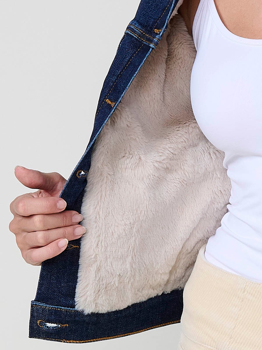 Women’s dark blue denim jacket with faux fur body lining, quilted sleeves, removable collar and metallic button closure.