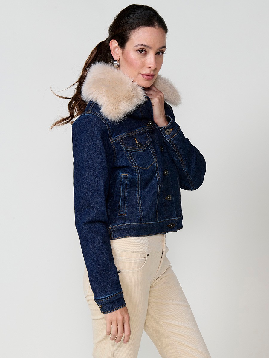 Women’s dark blue denim jacket with faux fur body lining, quilted sleeves, removable collar and metallic button closure.