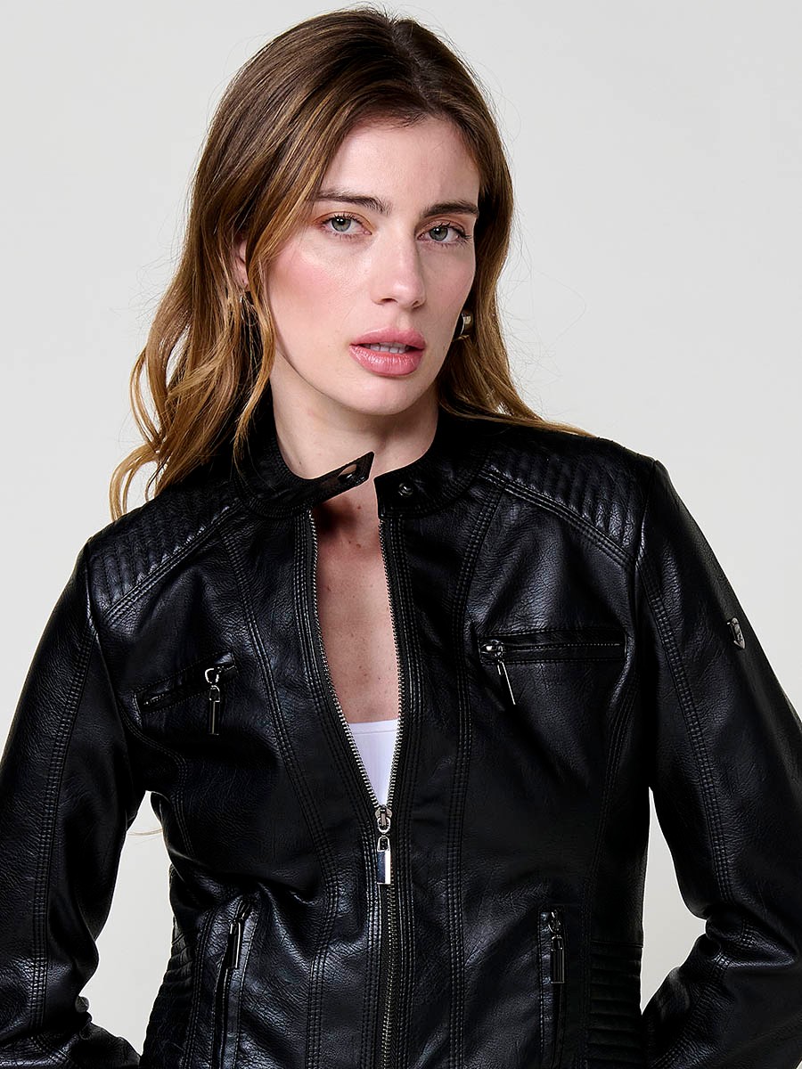 Women’s biker jacket in black faux leather, mao collar, metallic zippers, decorative pockets and quilted stitching details.