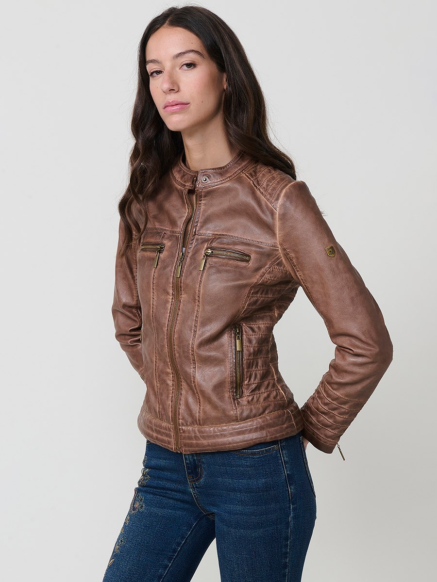 Women’s biker jacket in brown faux leather, mao collar, faux fur lining, quilted sleeves and metallic zippers.