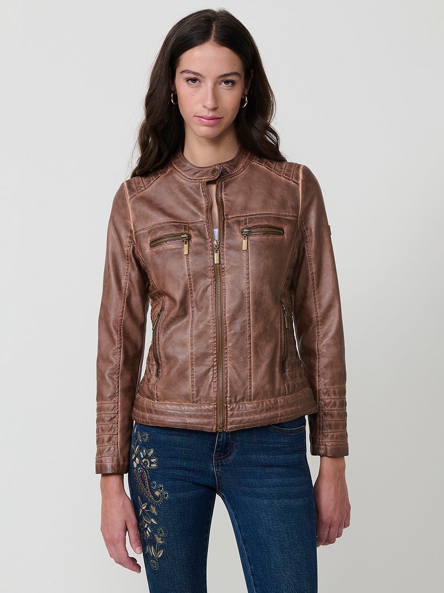 Women’s biker jacket in brown faux leather, mao collar, faux fur lining, quilted sleeves and metallic zippers.