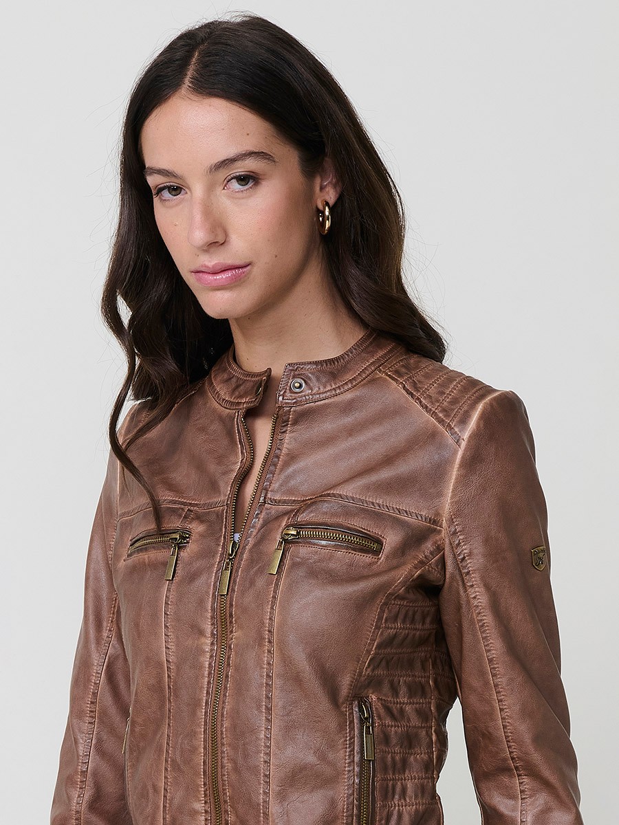 Women’s biker jacket in brown faux leather, mao collar, faux fur lining, quilted sleeves and metallic zippers.