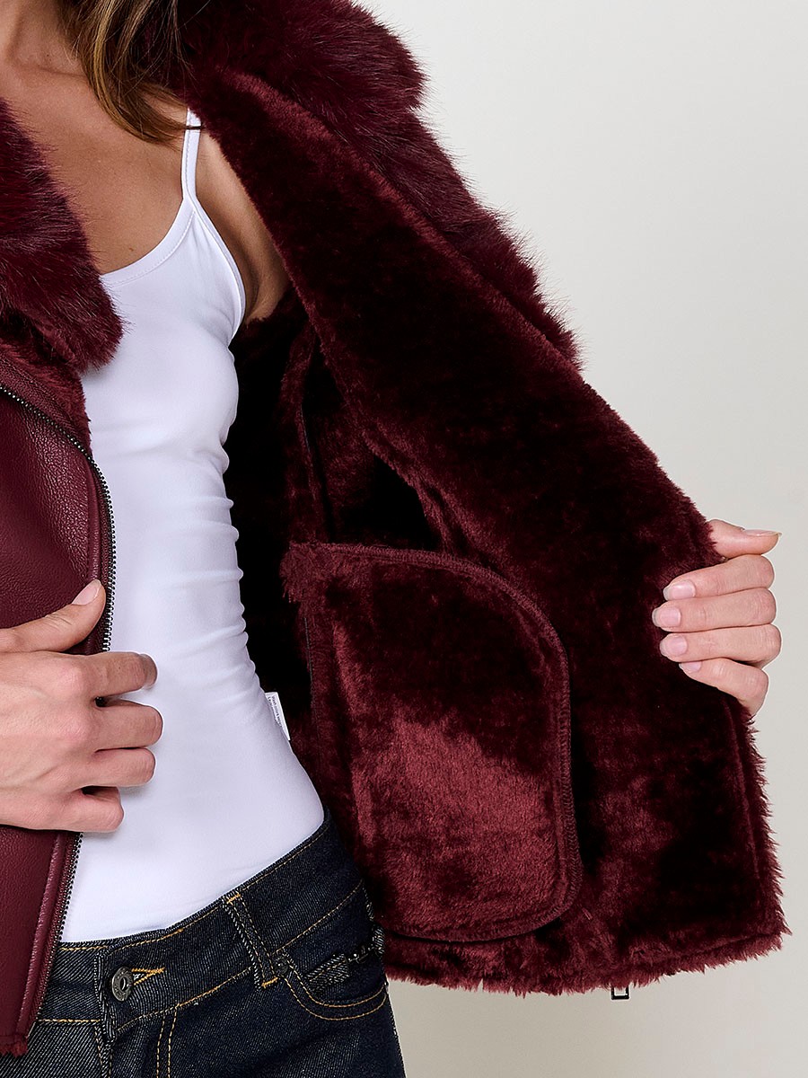 Women’s burgundy crossover jacket with detachable faux fur collar, versatile and elegant, made from 100% polyester.