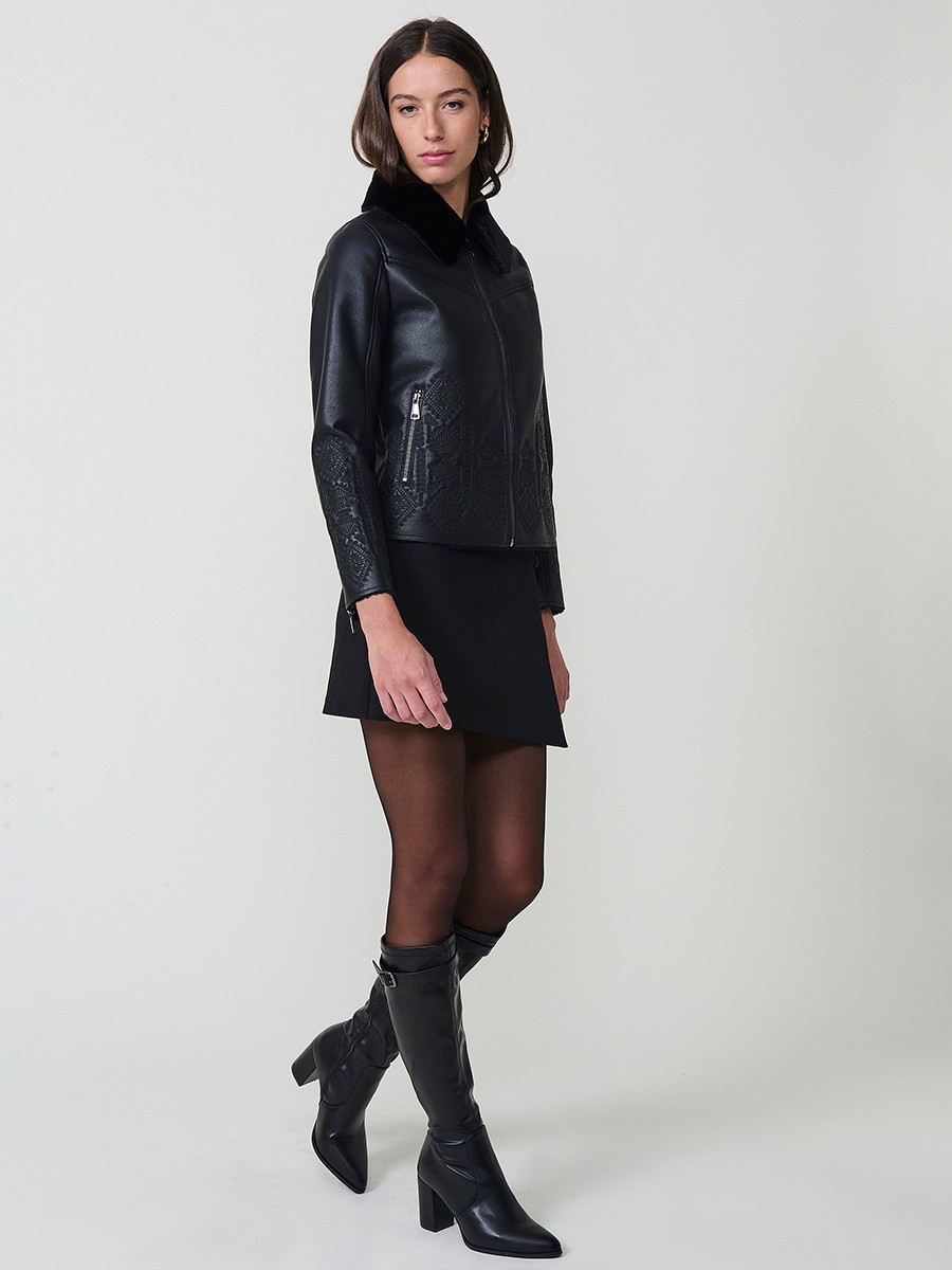 Women’s reversible jacket with faux leather exterior, faux fur lining, ethnic embroidery and metallic zippers.