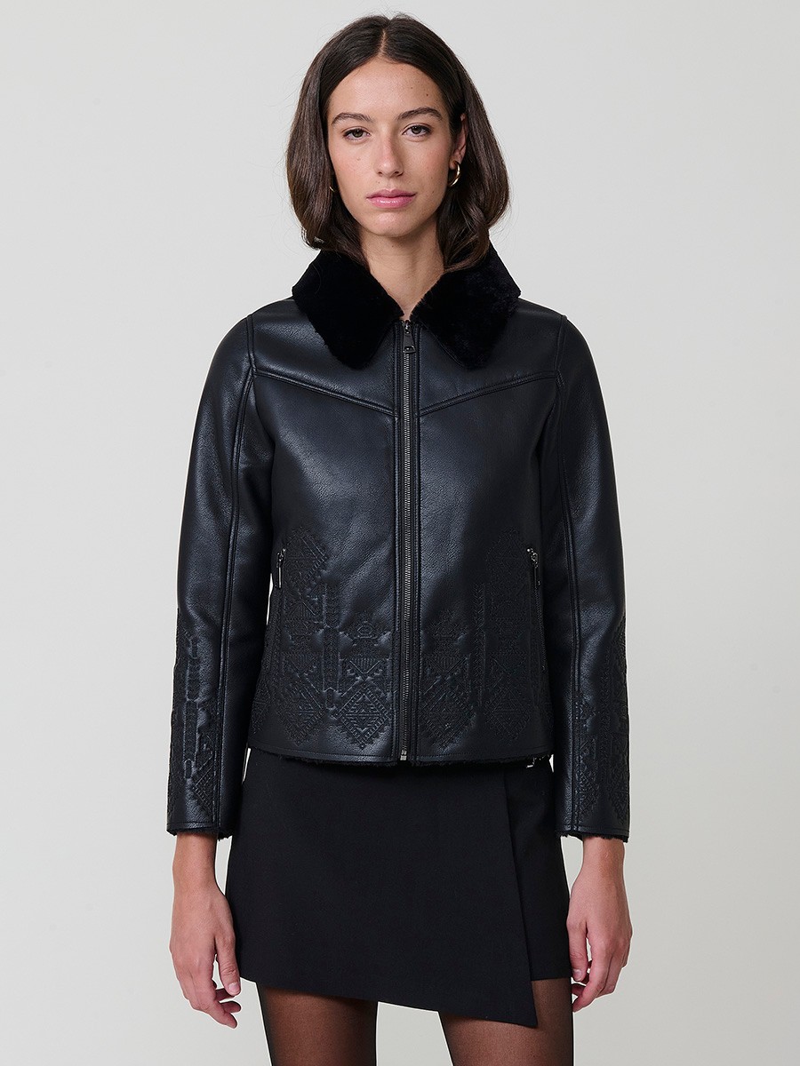 Women’s reversible jacket with faux leather exterior, faux fur lining, ethnic embroidery and metallic zippers.