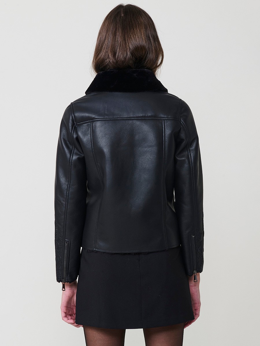 Women’s reversible jacket with faux leather exterior, faux fur lining, ethnic embroidery and metallic zippers.