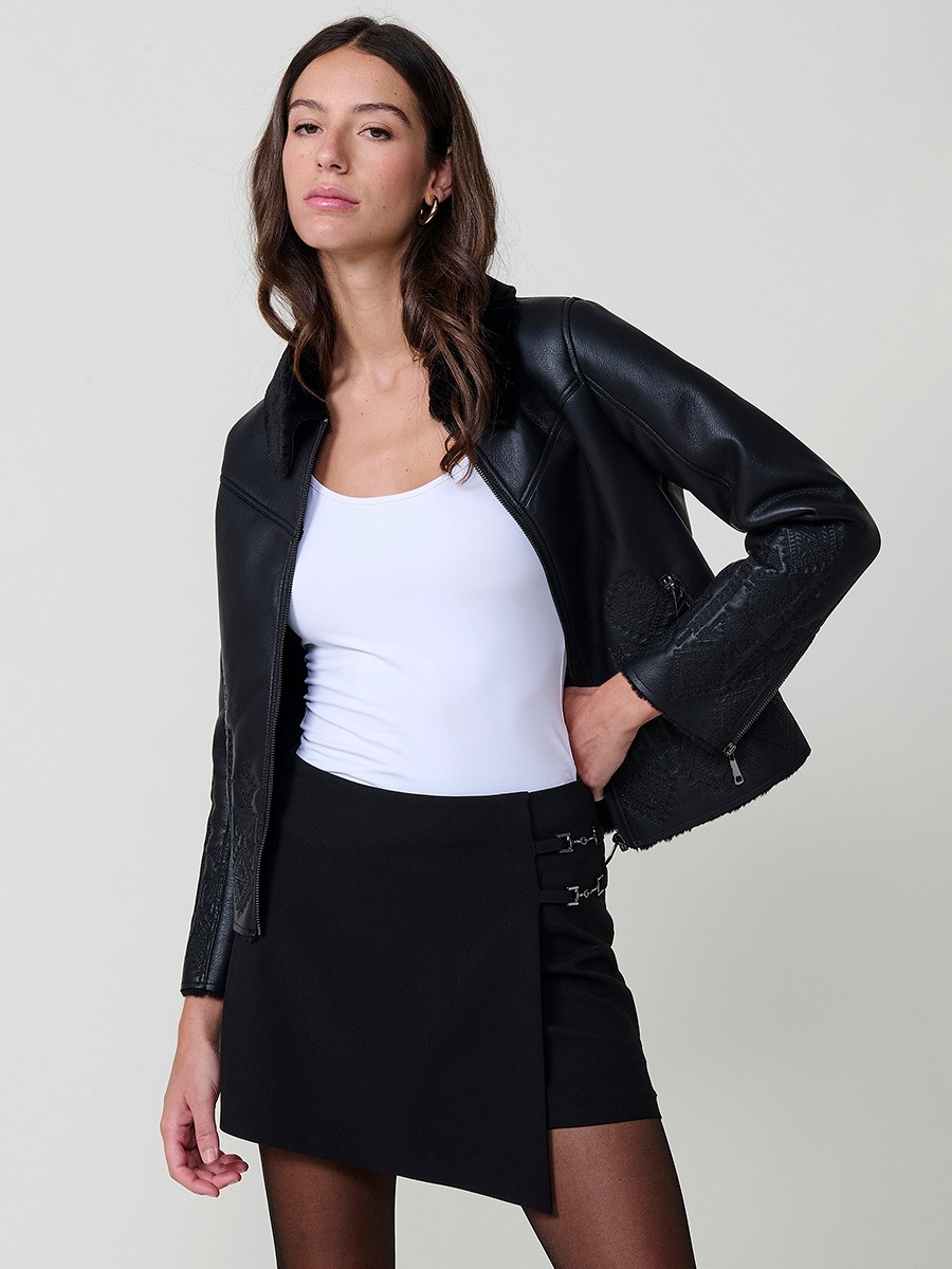 Women’s reversible jacket with faux leather exterior, faux fur lining, ethnic embroidery and metallic zippers.