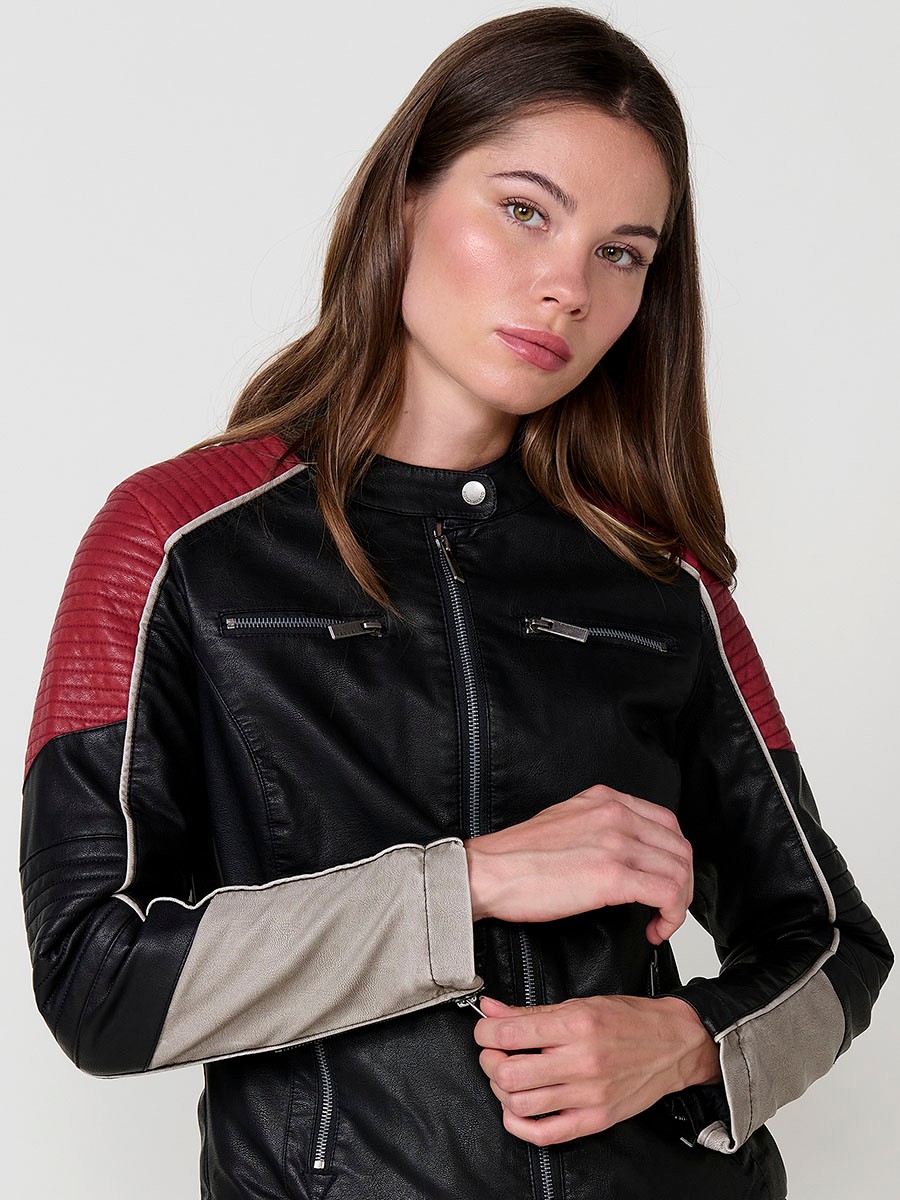 Women’s biker jacket in black faux leather with mao collar, contrast details, faux fur lining and metallic zippers.
