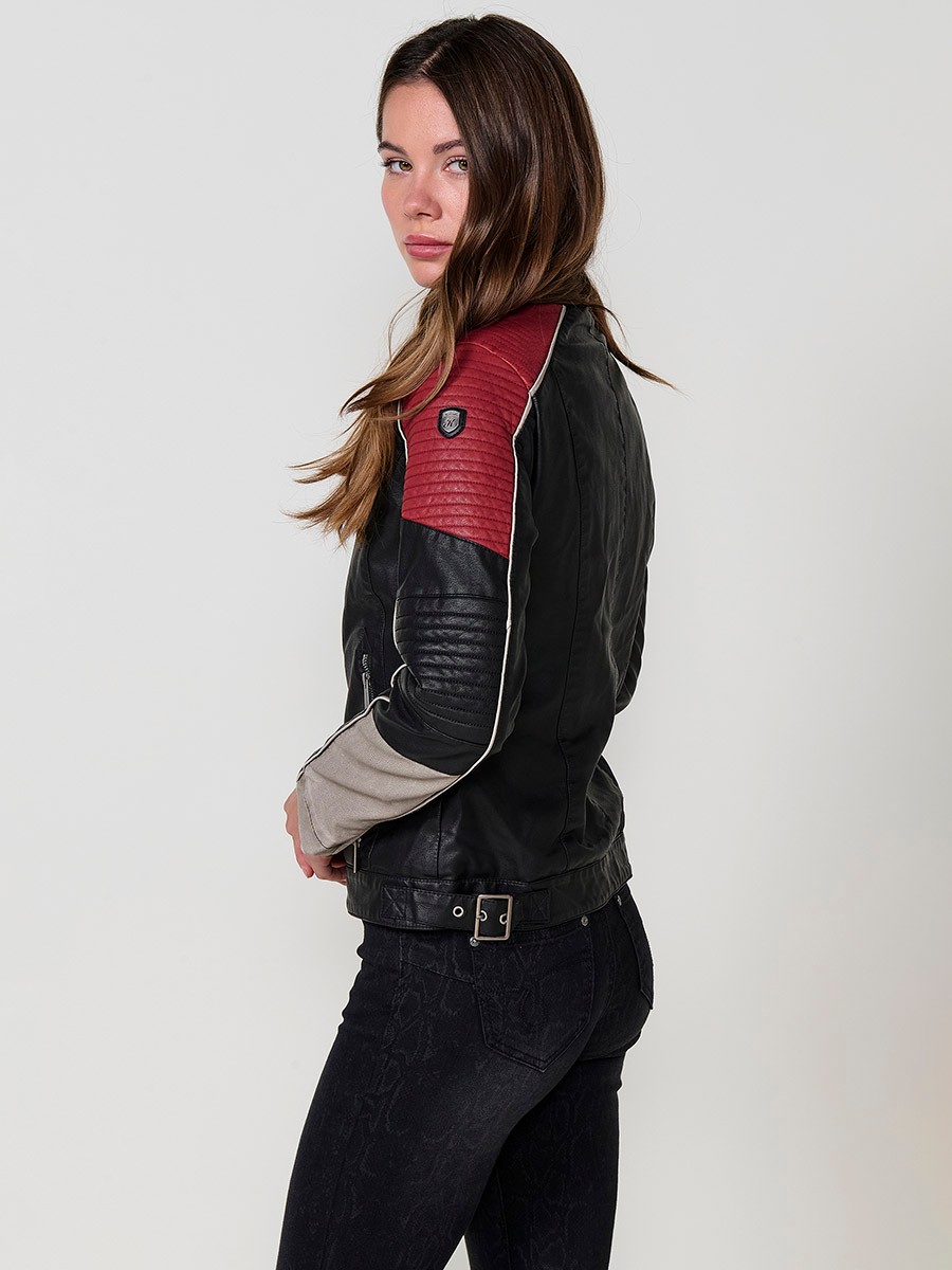 Women’s biker jacket in black faux leather with mao collar, contrast details, faux fur lining and metallic zippers.