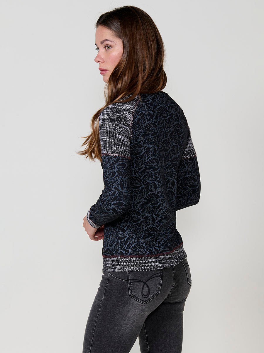 Black women’s top with jacquard knit at neckline, hem and cuffs, contrast print and metallic embroidery with studs.