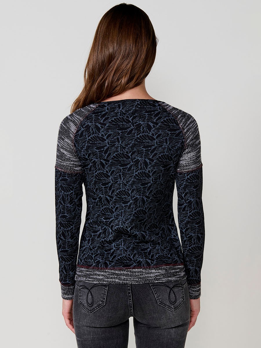 Black women’s top with jacquard knit at neckline, hem and cuffs, contrast print and metallic embroidery with studs.