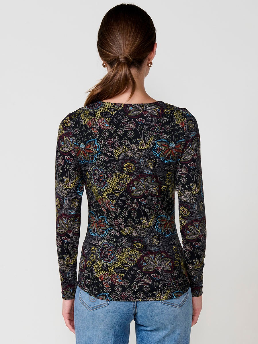 Women’s long sleeve floral top with V-neckline and metallic zipper with ring detail. Koröshi logo plate on the front.