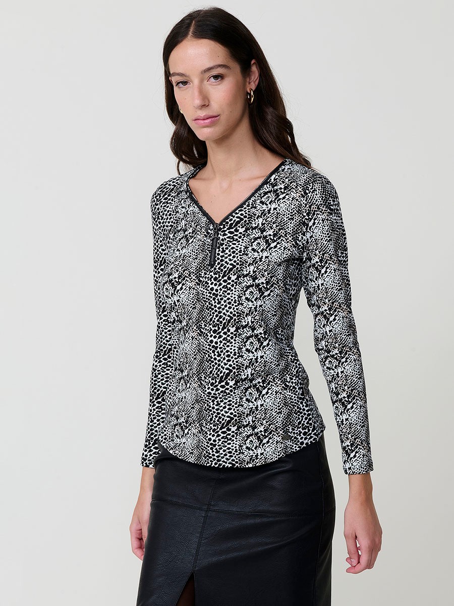 Women’s long sleeve animal print top with V-neckline, metallic ring zipper, and Koröshi logo plate.