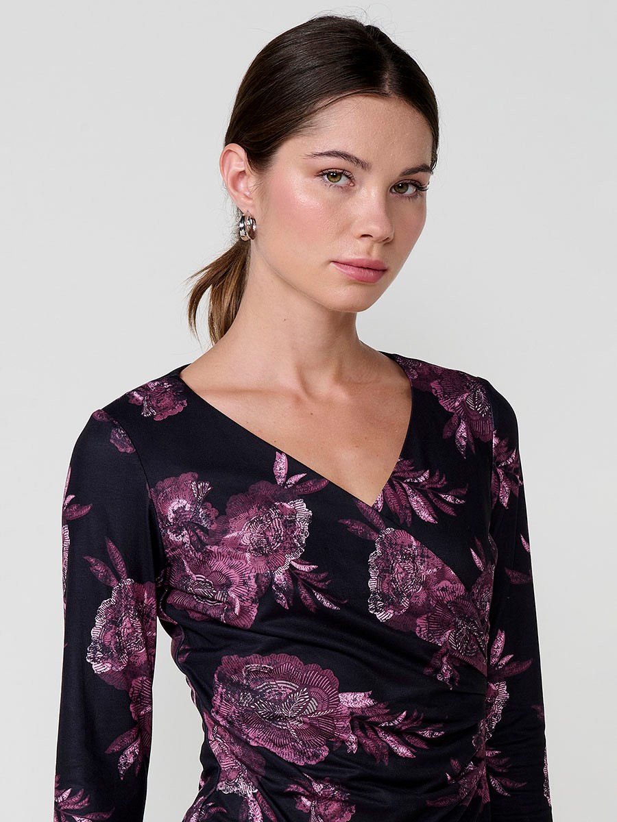 Women’s long sleeve floral top with wrap V-neckline and ruched front. Koröshi metal logo plate.