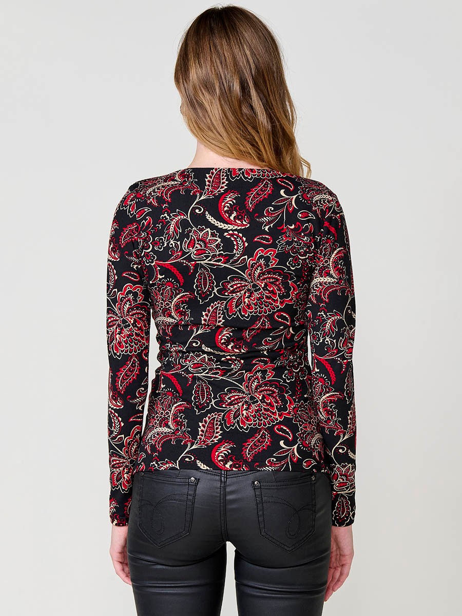 Women’s long sleeve top with paisley print, wrap neckline and ruched front. Metallic Koröshi logo plate.
