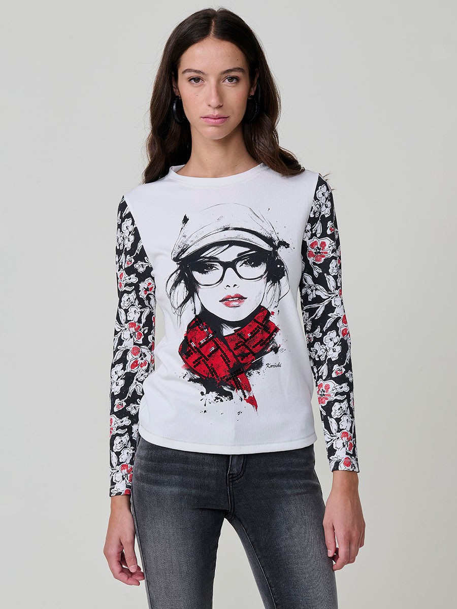 Women’s long sleeve ribbed top with girl print and sequin details on the front, contrast printed sleeves, and metallic thread seams.