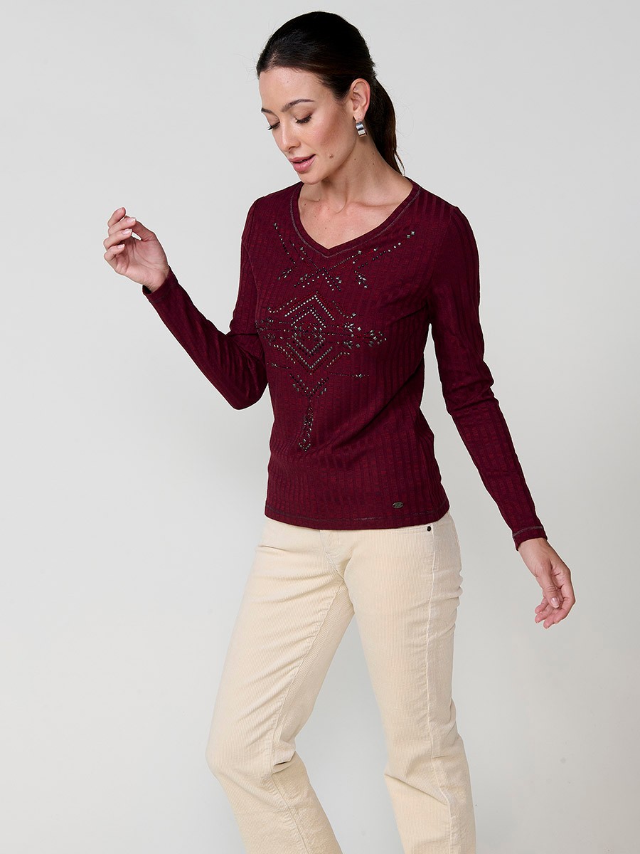 Women’s long sleeve ribbed top with melange effect, V-neckline and ethnic motif with studs and shiny accents.