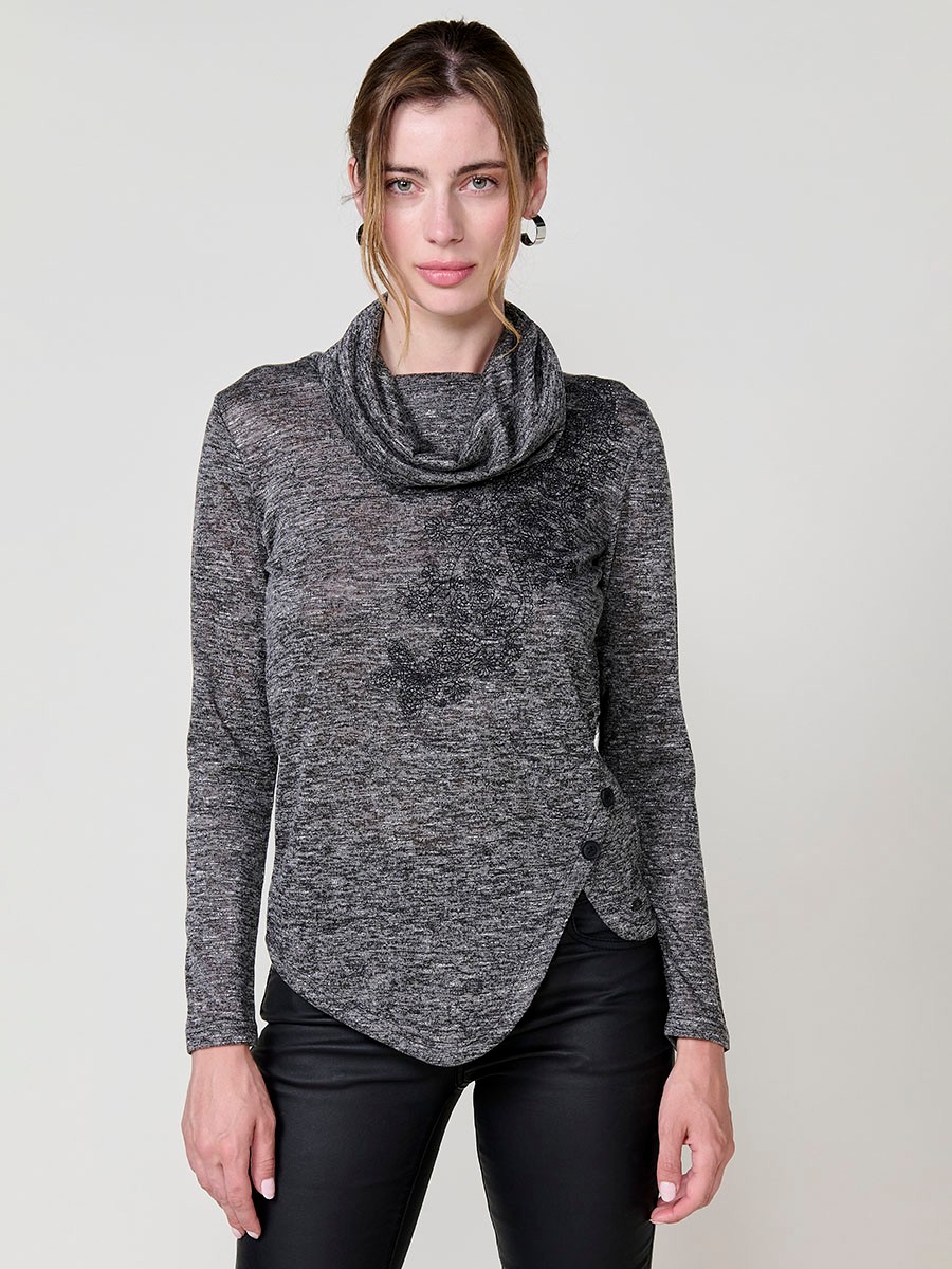 Women’s long sleeve turtleneck top in flamé melange fabric with asymmetric hem, diagonal buttons and shiny embroidery.