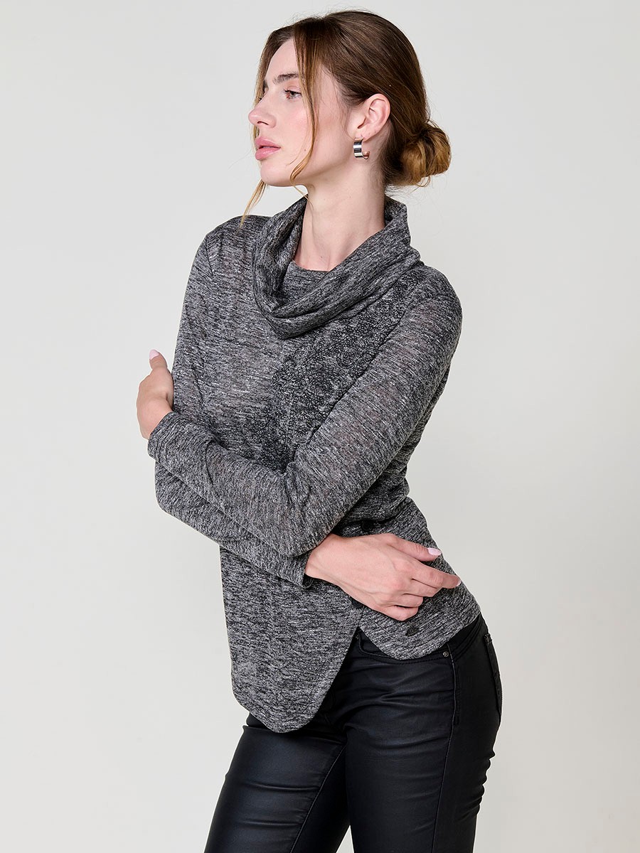 Women’s long sleeve turtleneck top in flamé melange fabric with asymmetric hem, diagonal buttons and shiny embroidery.