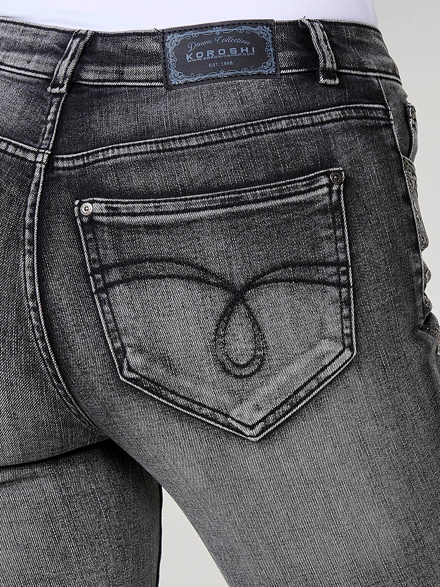 Pantalons texans negres dona boot cut amb tacs metàl·lics de colors