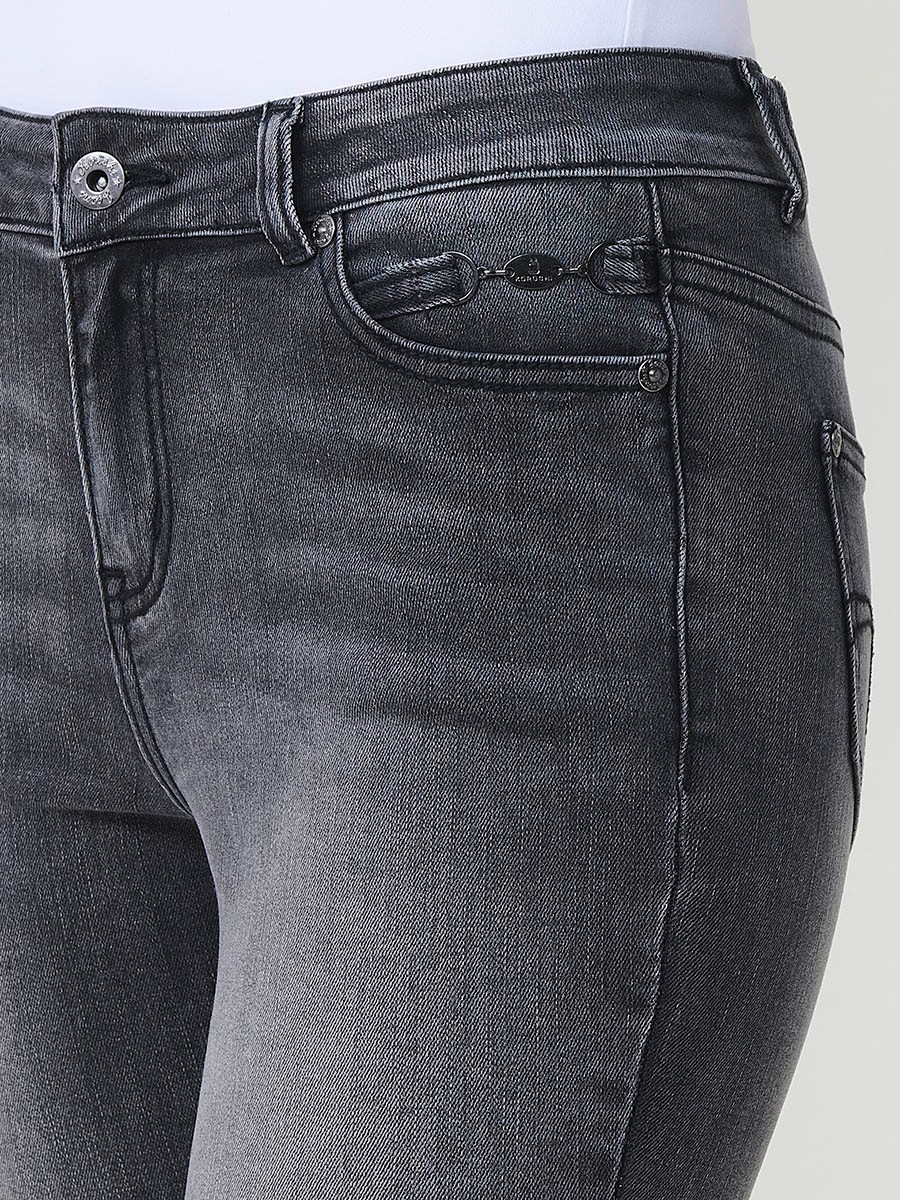 Jeans slim negro de mujer en denim elástico, tiro medio, cinco bolsillos, cierre metálico y placa Koröshi en el frontal.