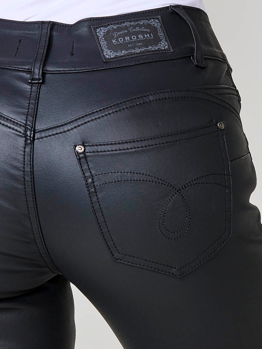Women’s black coated biker-style slim push up pants with mid-rise, front zip pockets, double metal button closure and topstitch details.