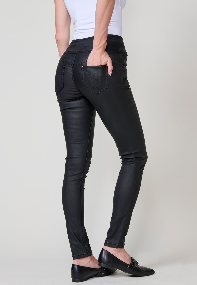 Women’s black high-waisted coated corset slim push up pants with five pockets, zip closure and three metallic buttons.