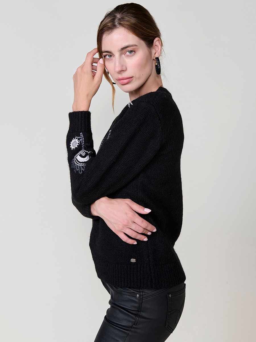 Women’s knit sweater with long sleeves, round neckline, floral embroidery on front and sleeve, Koröshi metal logo plate at hem.