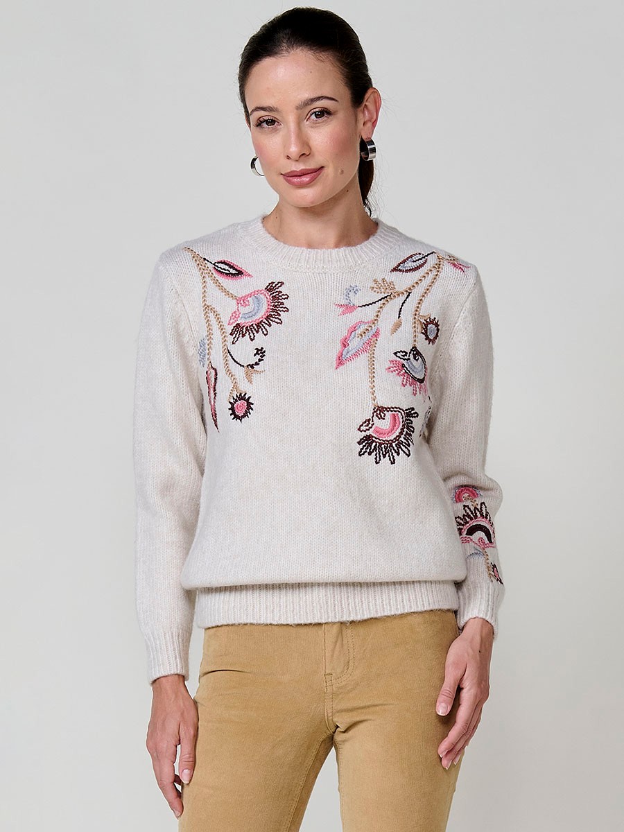 Women’s ivory knit sweater with long sleeves, round neckline, floral embroidery on front and sleeve, Koröshi metal logo plate at hem.