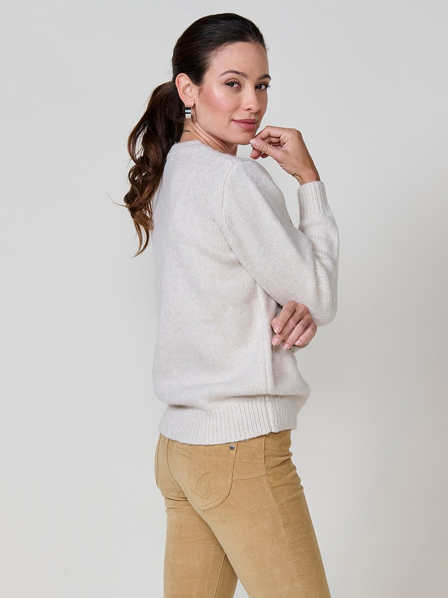 Women’s ivory knit sweater with long sleeves, round neckline, floral embroidery on front and sleeve, Koröshi metal logo plate at hem.