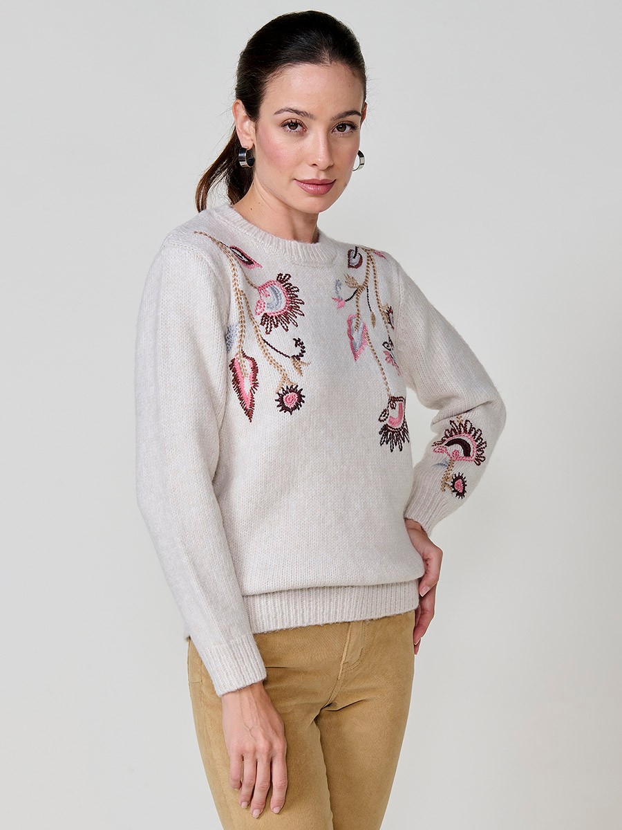 Women’s ivory knit sweater with long sleeves, round neckline, floral embroidery on front and sleeve, Koröshi metal logo plate at hem.