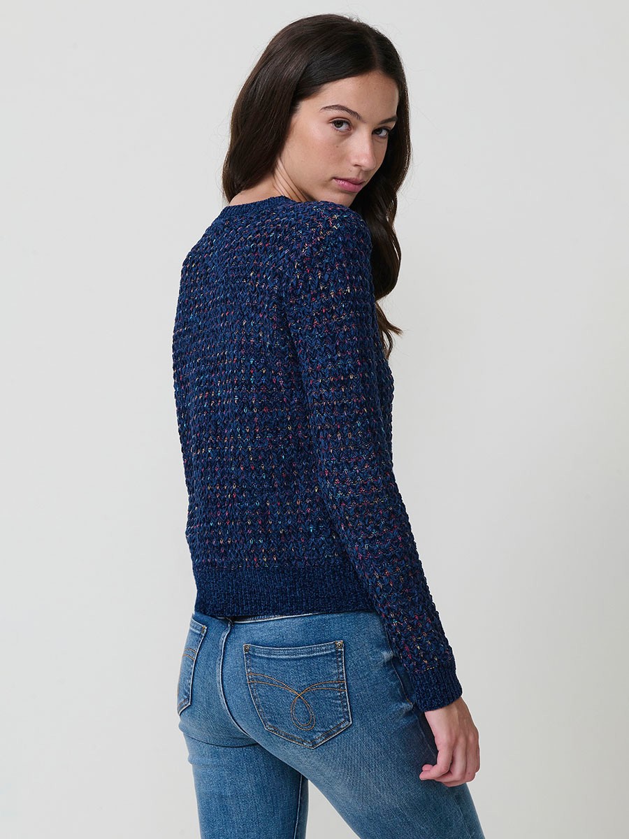Jersey de punto para mujer, con escote redondo, manga larga y diseño de corazones multicolor. Detalle de placa metálica con logo Koröshi