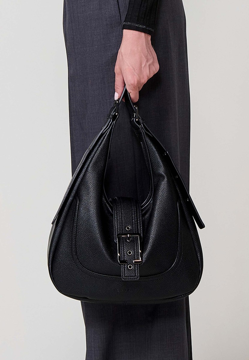 Faux leather women’s shoulder bag with top zipper closure, metal buckle detail and inner pocket.