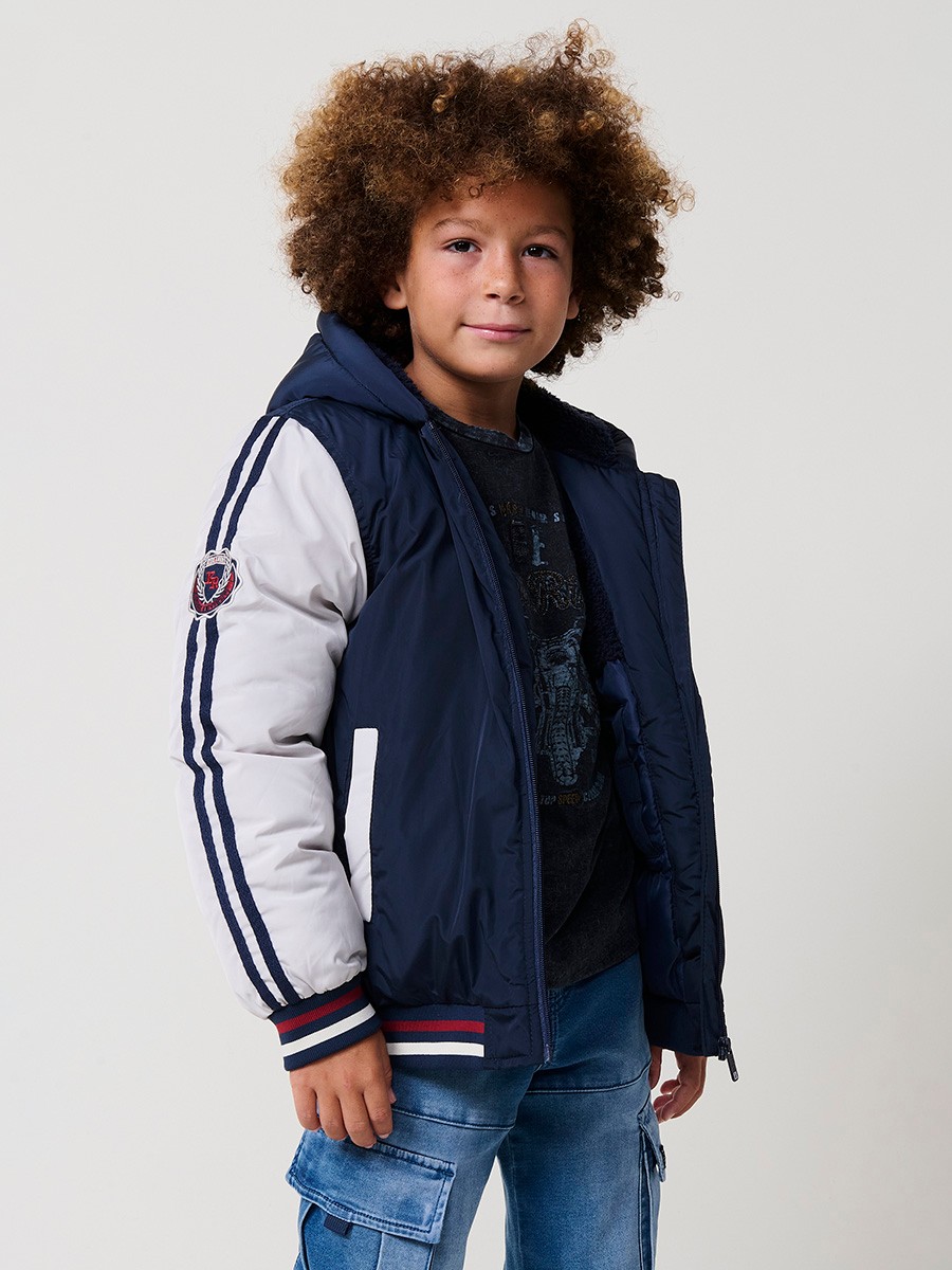 Blouson matelassé pour garçon, coloris navy avec capuche. Chaud et confortable, idéal pour l’hiver.