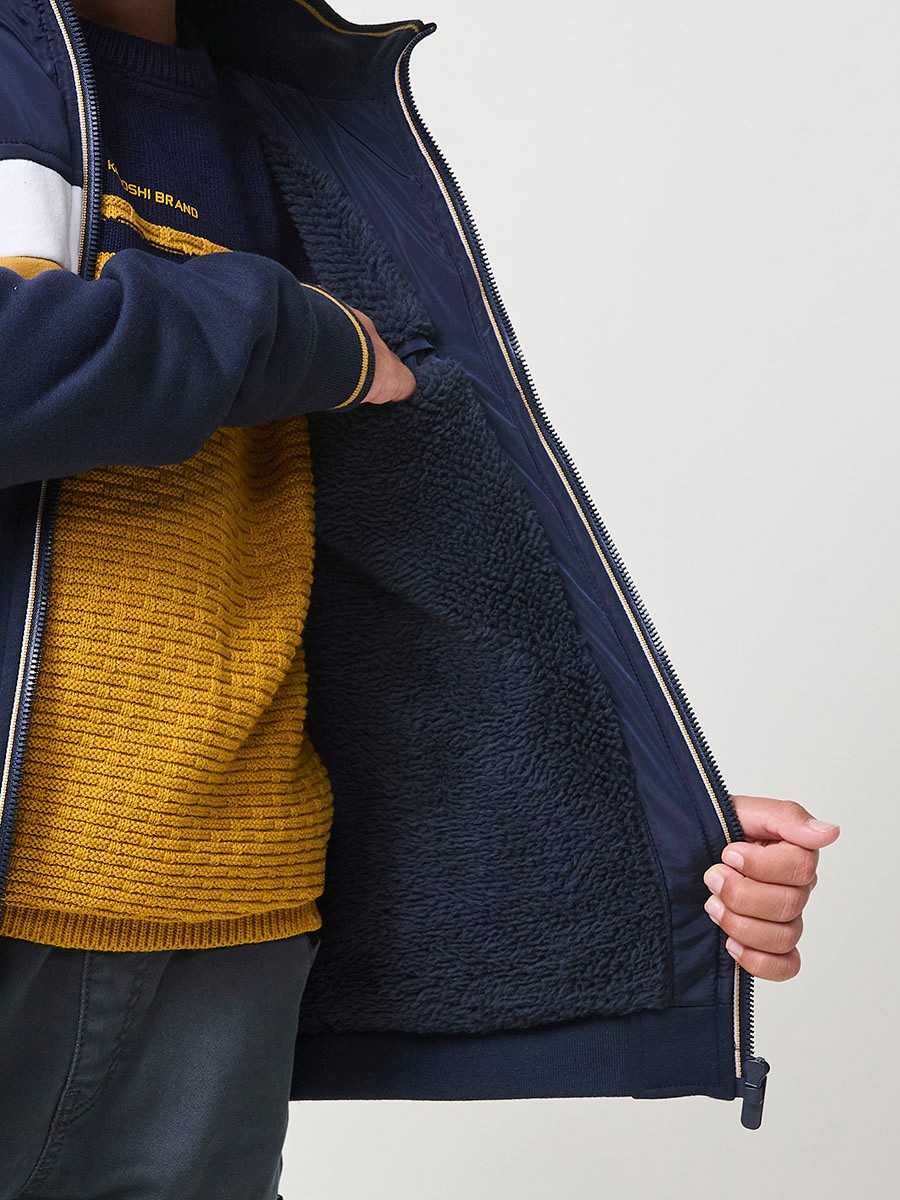 Veste garçon navy en molleton de coton et polyester, doublée et avec capuche amovible.