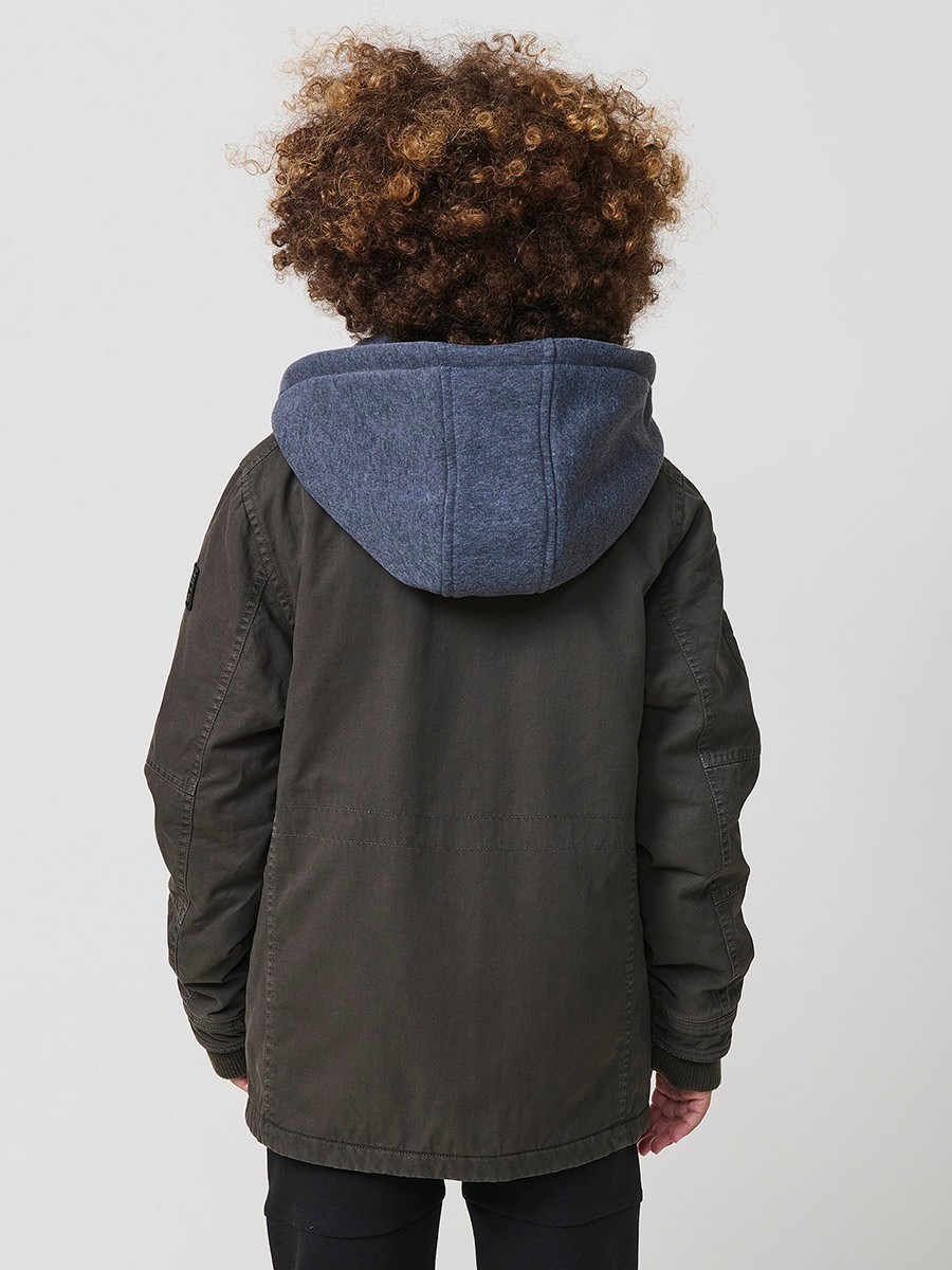 Cazadora de niño en algodón efecto lavado color verde oliva con capucha desmontable en felpa. Diseño práctico, urbano y confortable.